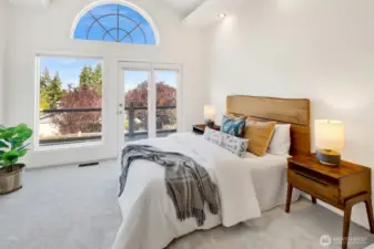 The main level primary bedroom has access to the wrap-around deck