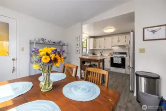 Cheerful dining area with fully-equipped kitchen.