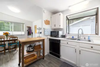 Garden window, light, and space to bake, cook, or serve your favorite beverage.