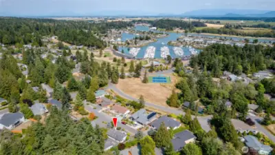 A view of the athletic court, pool, marina, and golf course (to the left.) All within walking distance. La Conner is a 5 minute drive.