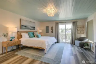 The stunning and spacious primary suite boasts an en-suite bath and private deck overlooking the canal.