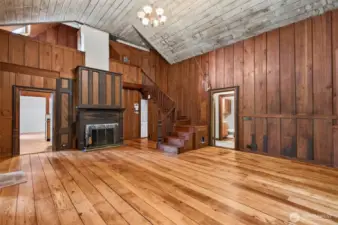 Beautiful fireplace with wood storage cabinet above. Stairs up to the loft bedroom, and walk in attic/storage space.