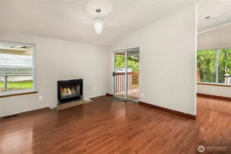 Comfortable living area with fireplace and sliding door to the deck for easy indoor/outdoor flow.