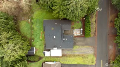 This property features abundant parking with a wide driveway and an additional Car Port. The yard has a peaceful, evergreen backdrop and an abundance of nature friends.