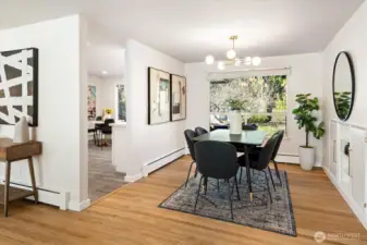 The dining room is located between the living room and kitchen.