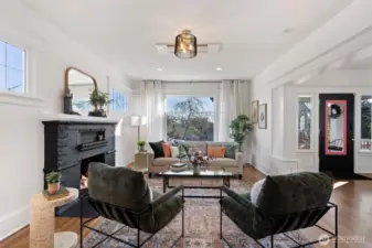 Light filled living room with fireplace and original millwork