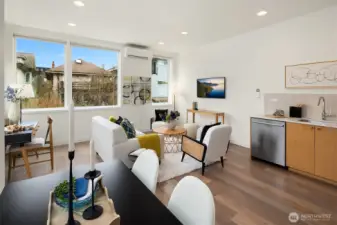 The open-plan living/dining/kitchen area on the second floor is bathed in natural light, with a flexible layout that lends itself well to different configurations.