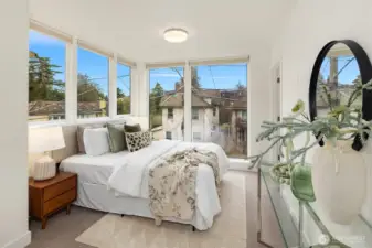 The generously sized primary bedroom on the top floor (also with en-suite bathroom) has the best light in the home.