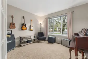 Just off the entry is the "den" or "office" with French doors, but used here as a music room.