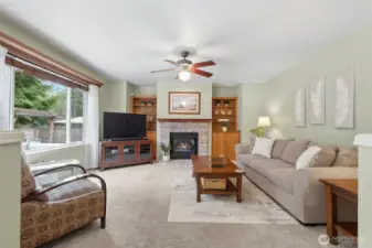 Family room off the kitchen - with ceiling fan, gas fireplace, built-ins and another HUGE window looking out onto the deck.