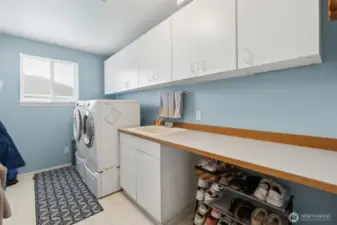 A laundry room with so much STORAGE - this is so helpful when managing and folding laundry.