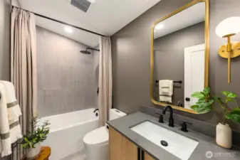 Just upstairs, you will find the first of two bathrooms. Featuring a deep full tub & two shower heads, a rainfall head and handheld shower head for a full spa experience.