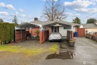 Two car ports and 30' RV parking on the side of the home.