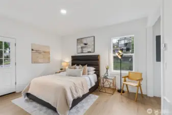 Primary Bedroom with a walk-in closet, and ensuite bathroom on the main level. Door to back porch.