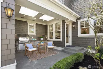 Outdoor covered built-in grilling area with skylights off the kitchen.