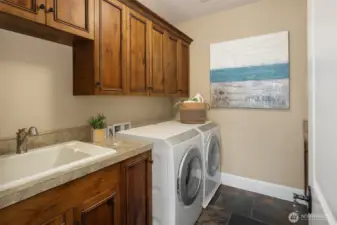 Large laundry room with storage and counter space.