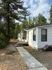 A walkway leads to a small entry deck.