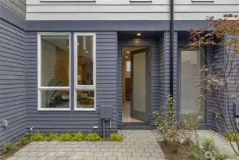 Step through the front entry and into the bright and open main level. Large windows and a welcoming door design bring plenty of natural light into the space, creating an airy ambiance.