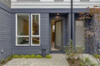 Step through the front entry and into the bright and open main level. Large windows and a welcoming door design bring plenty of natural light into the space, creating an airy ambiance.