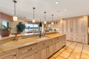 Ample countertop workspace, eating bar. Top quality cabinetry. Note the twin SubZero refrigerators each with dual pull out freezer compartments.