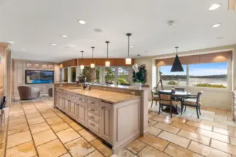 Huge kitchen workspace with bigscreen in the sitting area and vast eating bar counter.