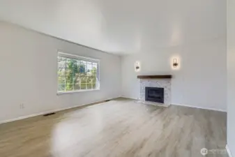Bright, open living room with durable LVP flooring - no carpets throughout the house means less cleaning, more relaxing