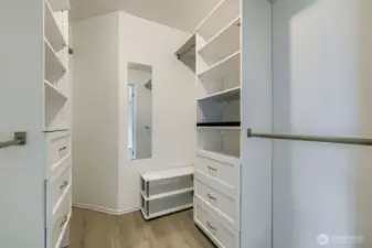 Huge walk-in closet with custom drawers and hanging bars, designed for effortless organization and everyday luxury