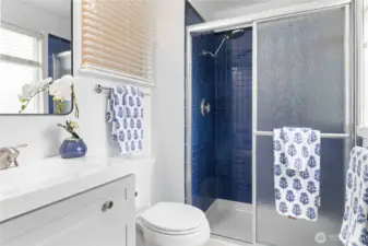 Enjoy this stylish primary bathroom featuring a tiled shower and modern finishes.