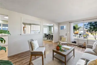The living room room flows into the kitchen and dining room . Such a great floor plan!