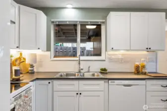 Notice the under the counter lighting! Beautiful tile backsplash too!