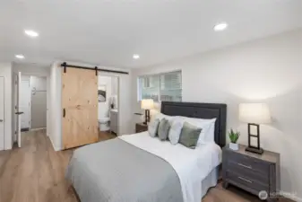 Primary bedroom & bath. Behind the barn door is a linen closet!