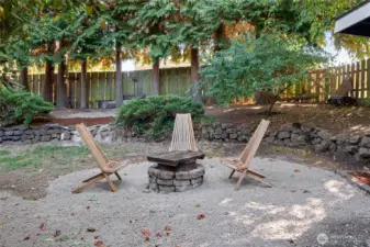Lovely rockery hard scape and mature landscaping add to the beauty of this back yard.