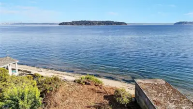 That is Blake Island State Park in the front and Vashon Island to the south. The Fauntleroy to Southworth Ferry is 5 minutes away.
