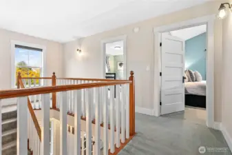 Here we have one of the guestrooms on the left and the primary bedroom to the right.