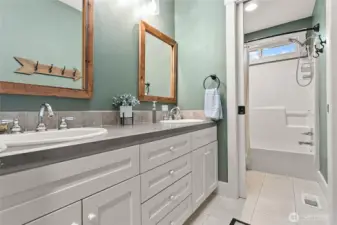Large upper level guest bathroom with dual sinks.