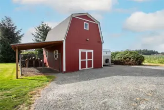 This detached "barn" would make an amazing shop or additional storage area ... bring your own vision to it! The carport has been used as an outdoor dog kennel.