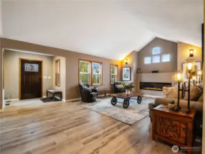 Open-concept entryway with vaulted ceilings and warm natural light