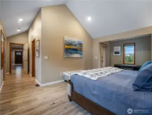 View from the primary bedroom toward the entry, passing the spacious walk-in closet and private ensuite