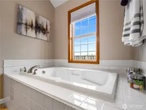 Unwind after long days in the soaking tub while enjoying peaceful views through the oversized window