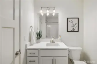 Upper-level full bathroom with contemporary vanity, modern lighting, and clean finishes designed for low-maintenance living on San Juan Island.