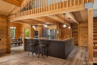 Spacious open concept kitchen with wrap-around island and eating nook.