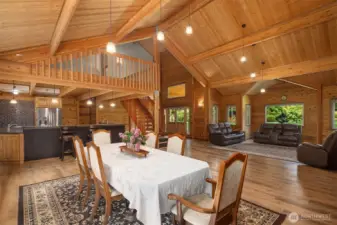 Open floor plan seamlessly connecting kitchen, dining, and living spaces with vaulted ceilings.