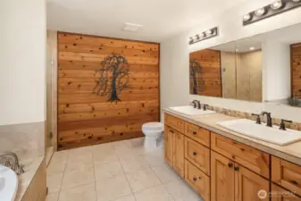 Full ensuite bath with two sink countertop off of primary bedroom.