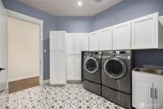 Laundry room with sink and linen closet.