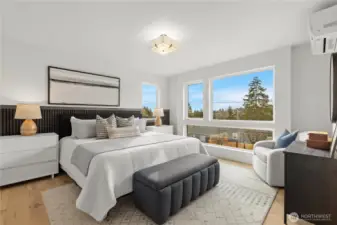 Large primary bedroom with views of mountains, water and territorial