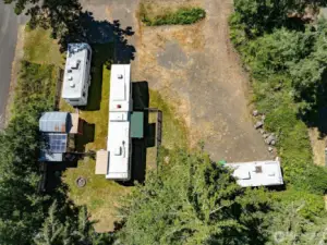 Corner lot with mature trees on the north side of the property. the two smaller RV's will be removed before closing.
