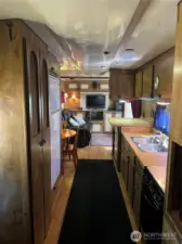 Galley kitchen leads to living room. Lots of counter space and storage in this 40 ft Spacecraft.