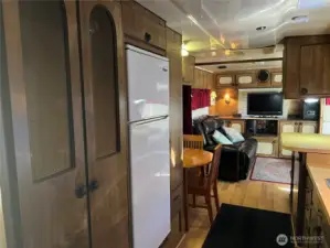 Washer/Dryer within double doors and refrigerator.