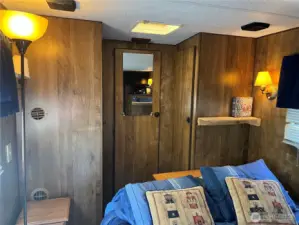 The closet has three doors to for lots of clothes and shoes.