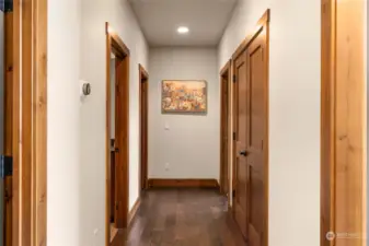 Hallway leading to shared bath and other bedrooms.